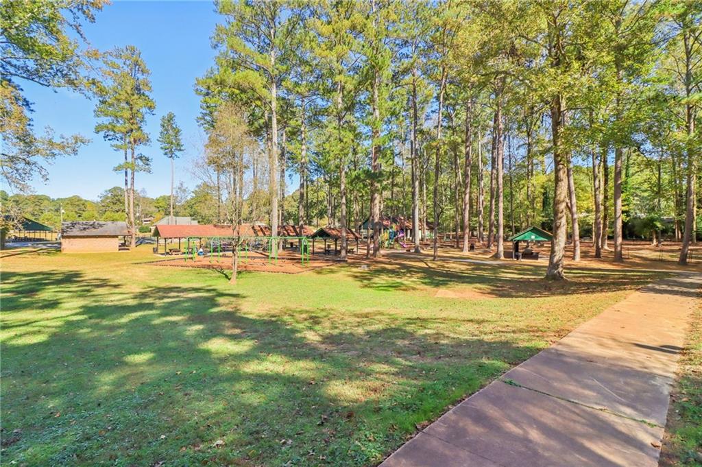 957 Texel Lane Clarkston, GA 30021 - Photo 25 of 27 a view of outdoor space with swimming pool and trees