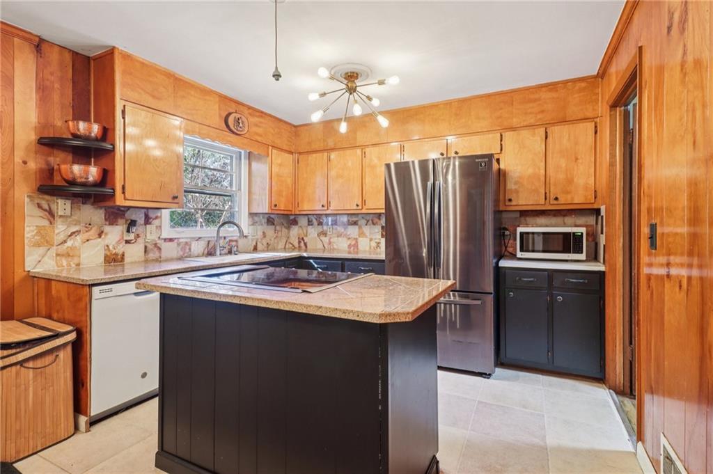 957 Texel Lane Clarkston, GA 30021 - Photo 8 of 27 a kitchen with stainless steel appliances granite countertop a sink stove and refrigerator