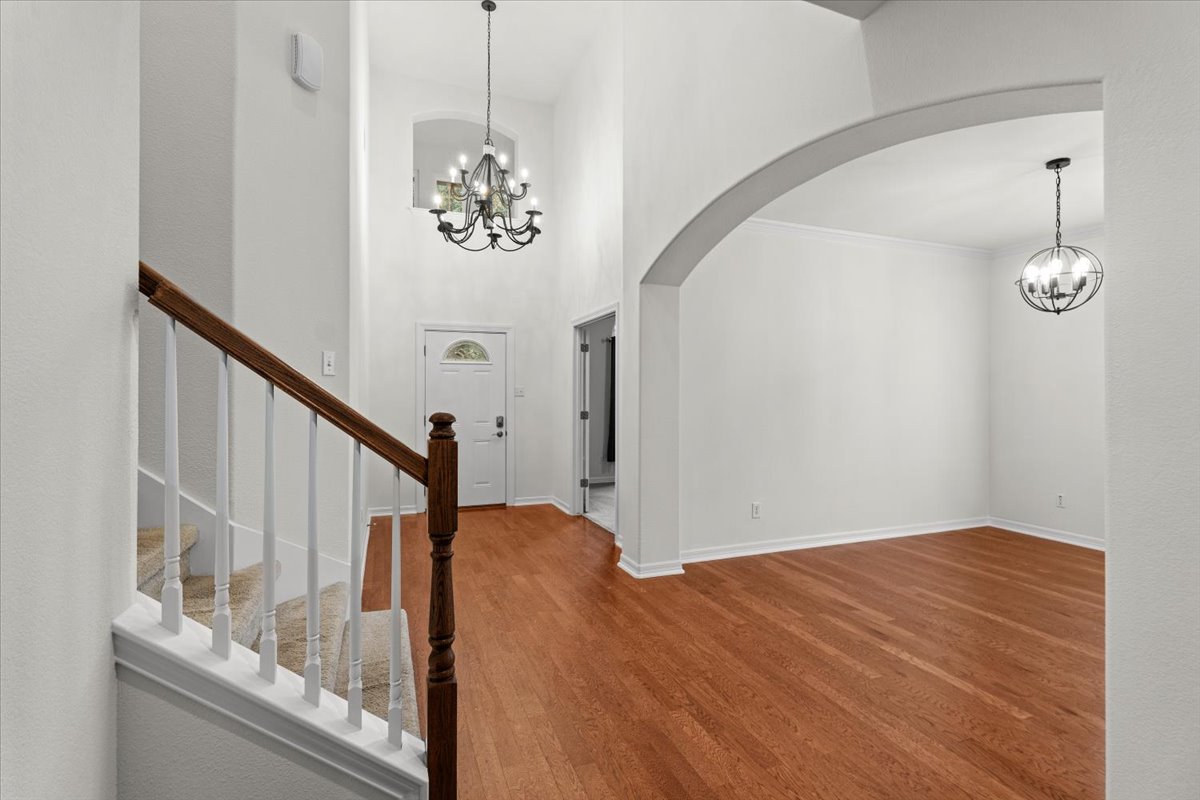 2304 Village View Loop Pflugerville, TX 78660 - Photo 18 of 40 A grand entrance with high ceilings and hardwood floors welcomes you into this inviting home.