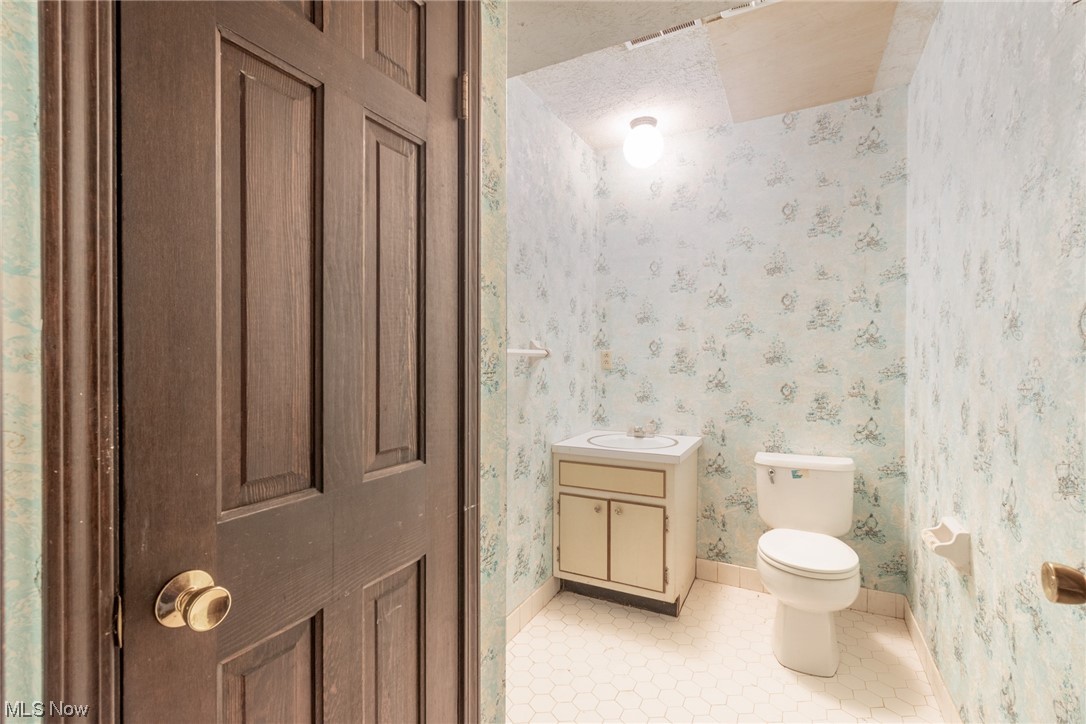 6038 Tippecanoe Road Canfield, OH 44406 - Photo 26 of 34 Half bathroom featuring toilet, a textured ceiling, tile floors, and vanity