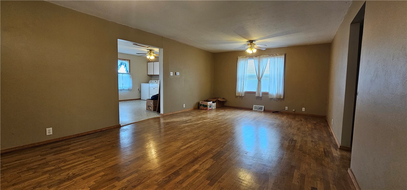 206 East Fifth Street St. Peter, IL 62880 - Photo 10 of 23 a view of a livingroom with wooden floor and a ceiling fan