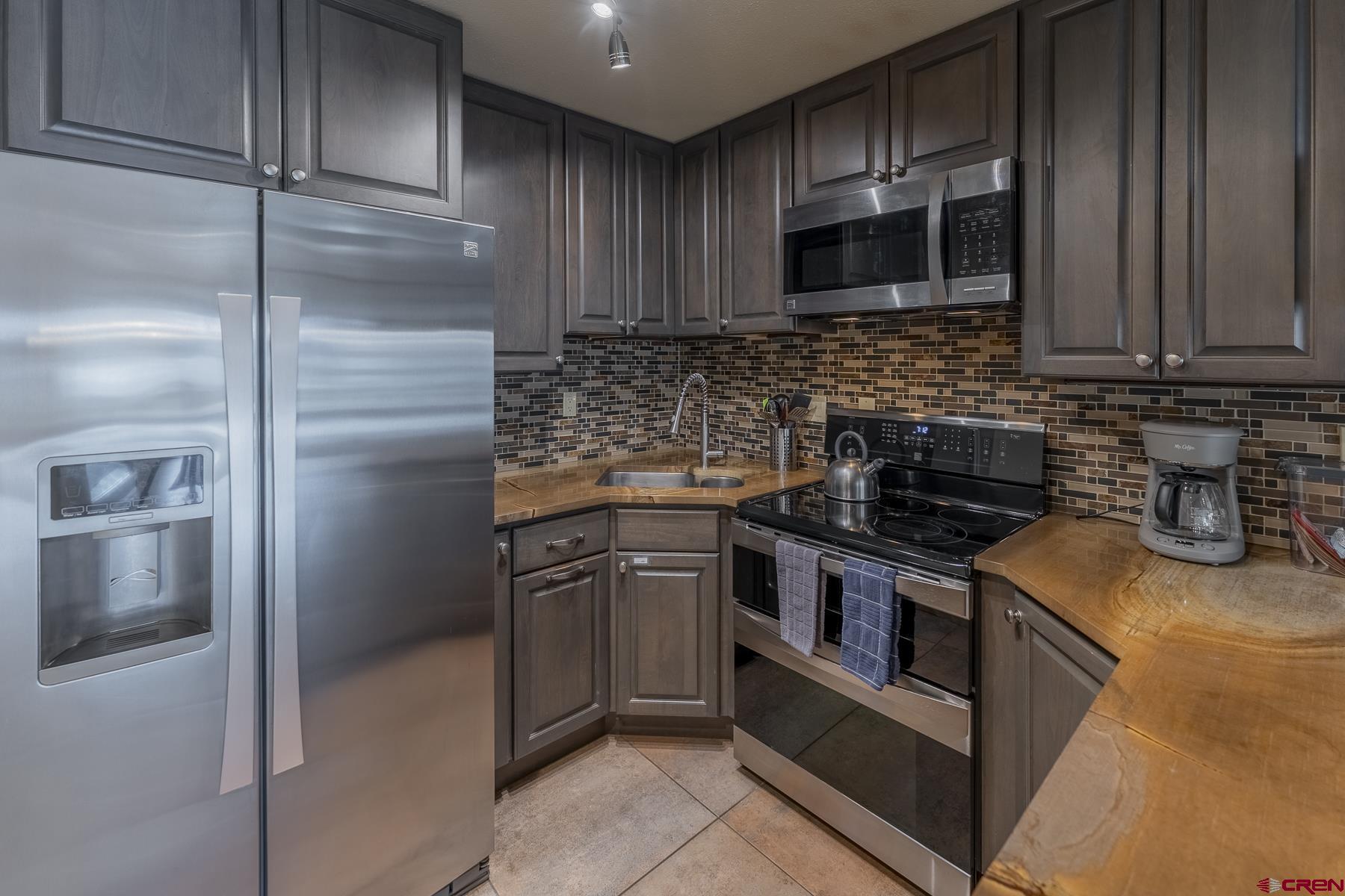 11 Morning Glory Way, Unit 14 Crested Butte, CO 81225 - Photo 13 of 44 a kitchen with a stove microwave and refrigerator