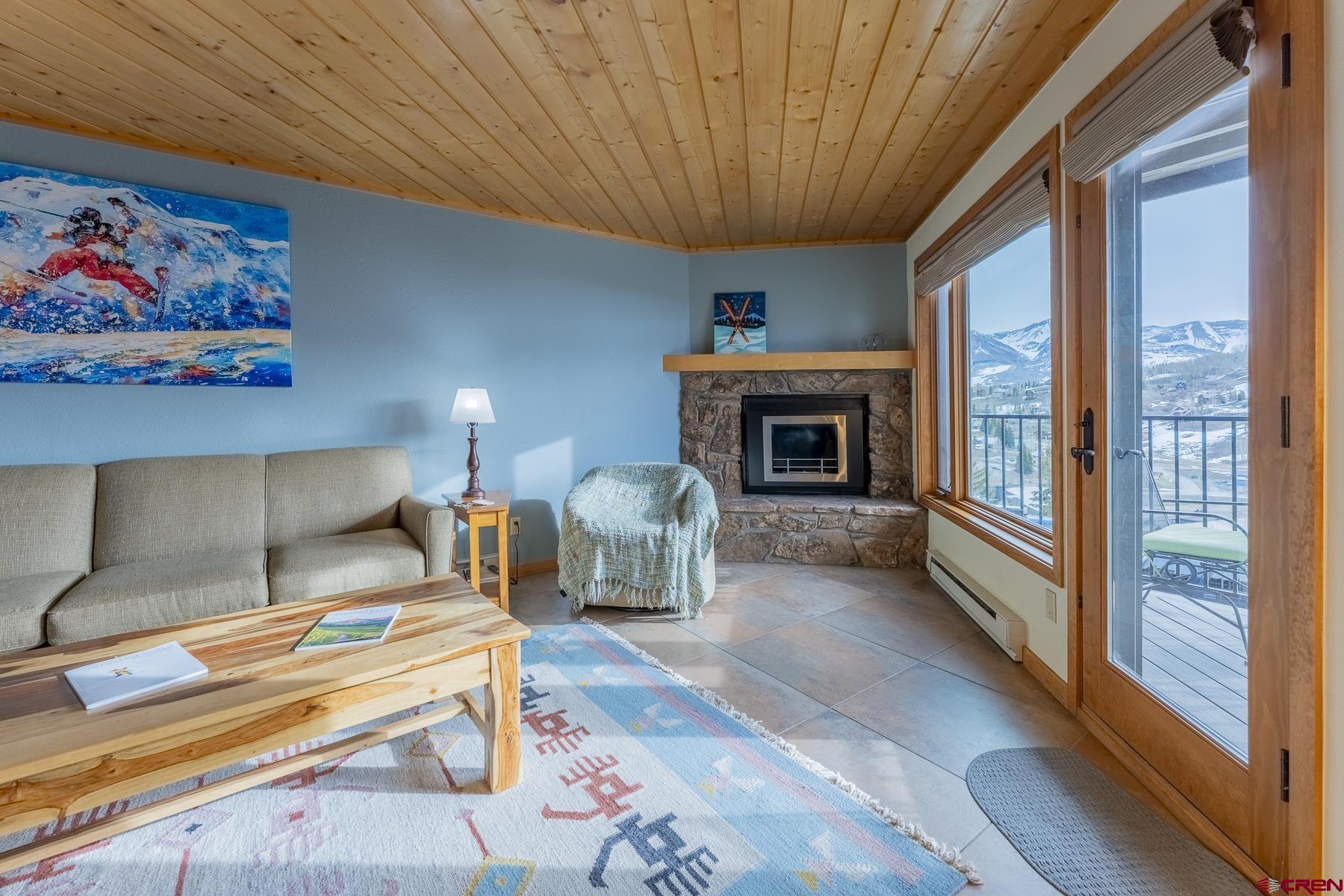 11 Morning Glory Way, Unit 14 Crested Butte, CO 81225 - Photo 17 of 44 a living room with furniture a fireplace and a large window