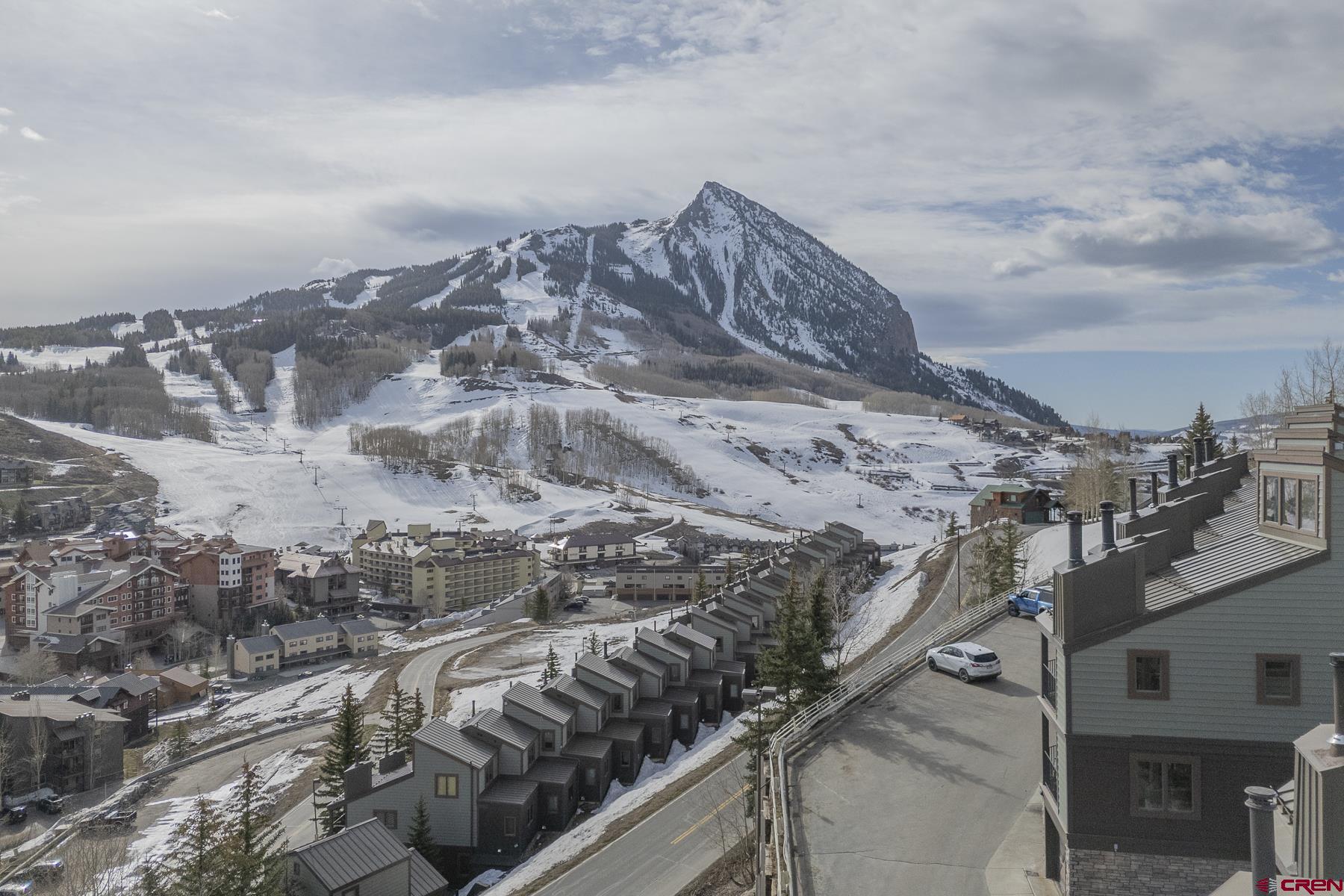 11 Morning Glory Way, Unit 14 Crested Butte, CO 81225 - Photo 2 of 44 a view of a city with mountains in the background