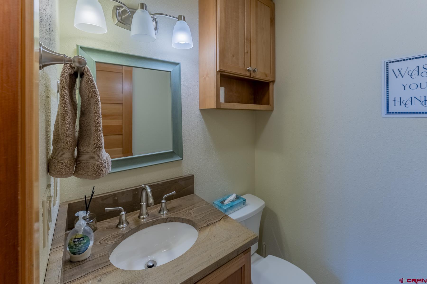 11 Morning Glory Way, Unit 14 Crested Butte, CO 81225 - Photo 21 of 44 a bathroom with a sink vanity mirror and toilet
