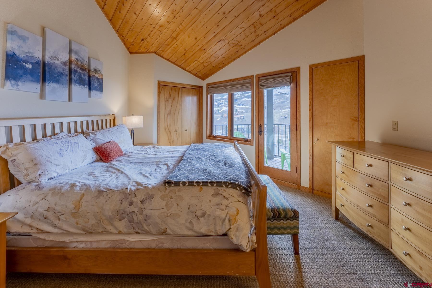 11 Morning Glory Way, Unit 14 Crested Butte, CO 81225 - Photo 22 of 44 a bedroom with a large bed and a window