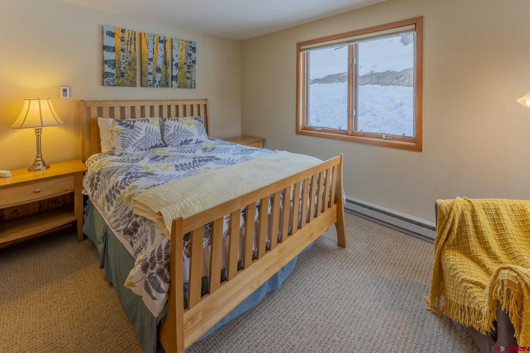 11 Morning Glory Way, Unit 14 Crested Butte, CO 81225 - Photo 27 of 44 a bed sitting in a bedroom next to a window