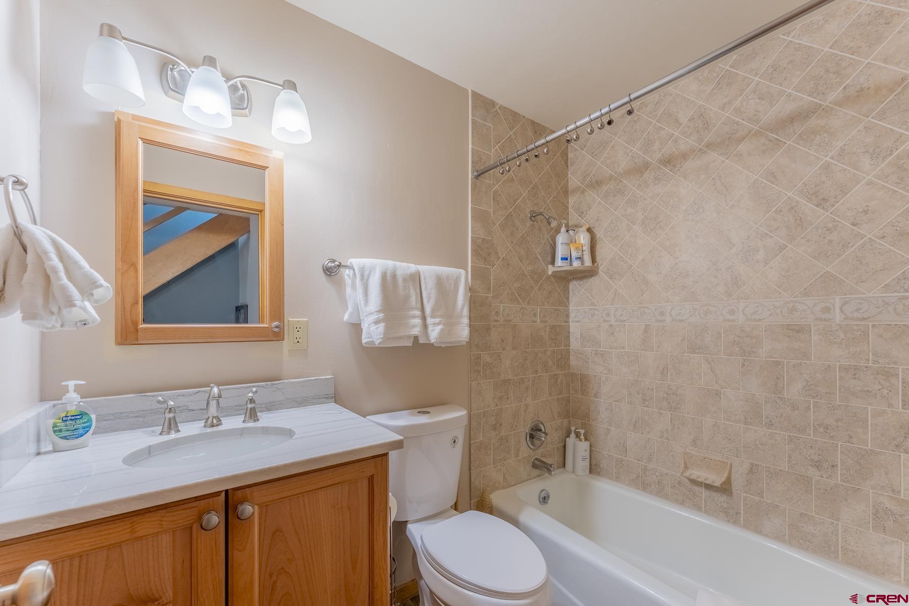 11 Morning Glory Way, Unit 14 Crested Butte, CO 81225 - Photo 30 of 44 a bathroom with a granite countertop sink toilet and shower