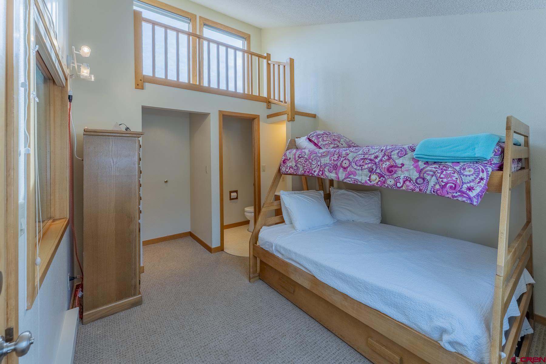 11 Morning Glory Way, Unit 14 Crested Butte, CO 81225 - Photo 31 of 44 a bedroom with a bed and a window