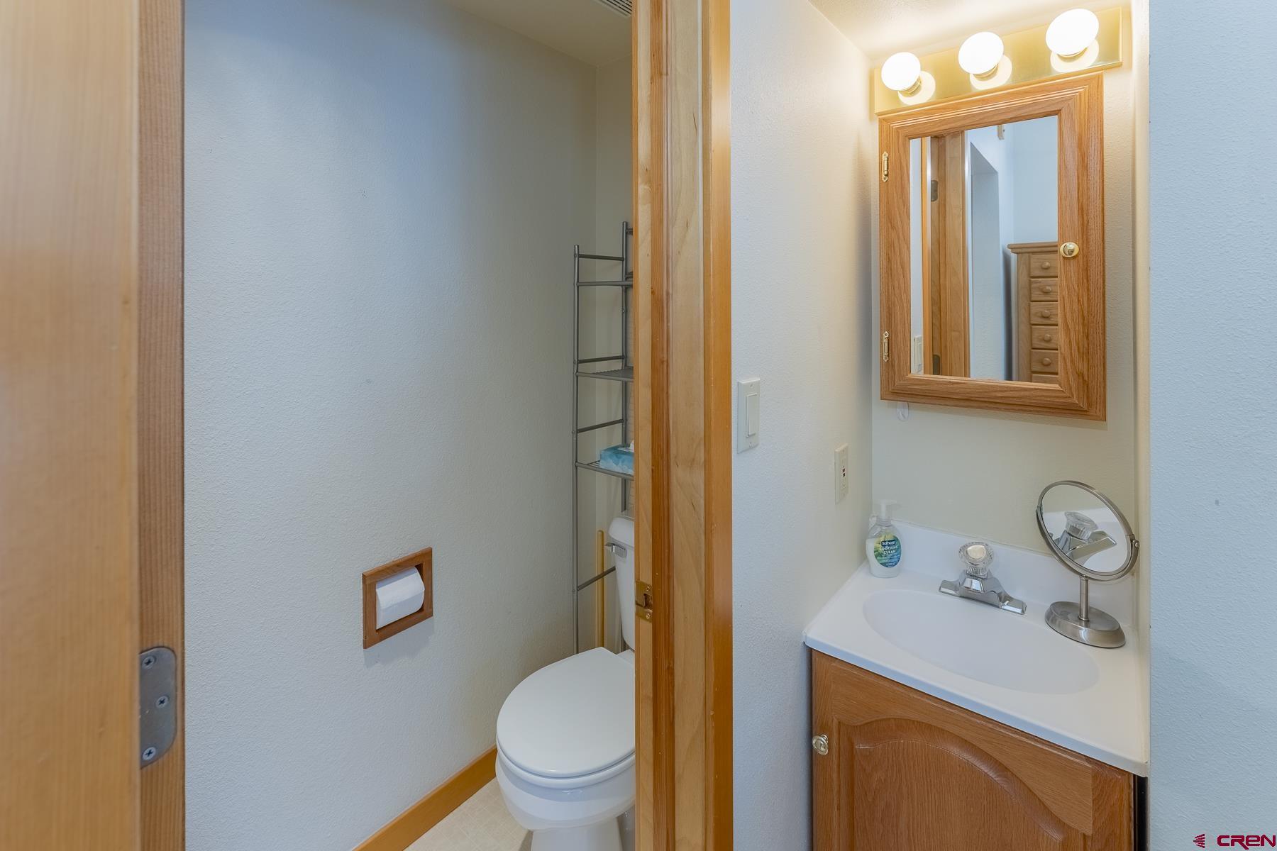 11 Morning Glory Way, Unit 14 Crested Butte, CO 81225 - Photo 34 of 44 a white toilet sitting next to a bathroom sink