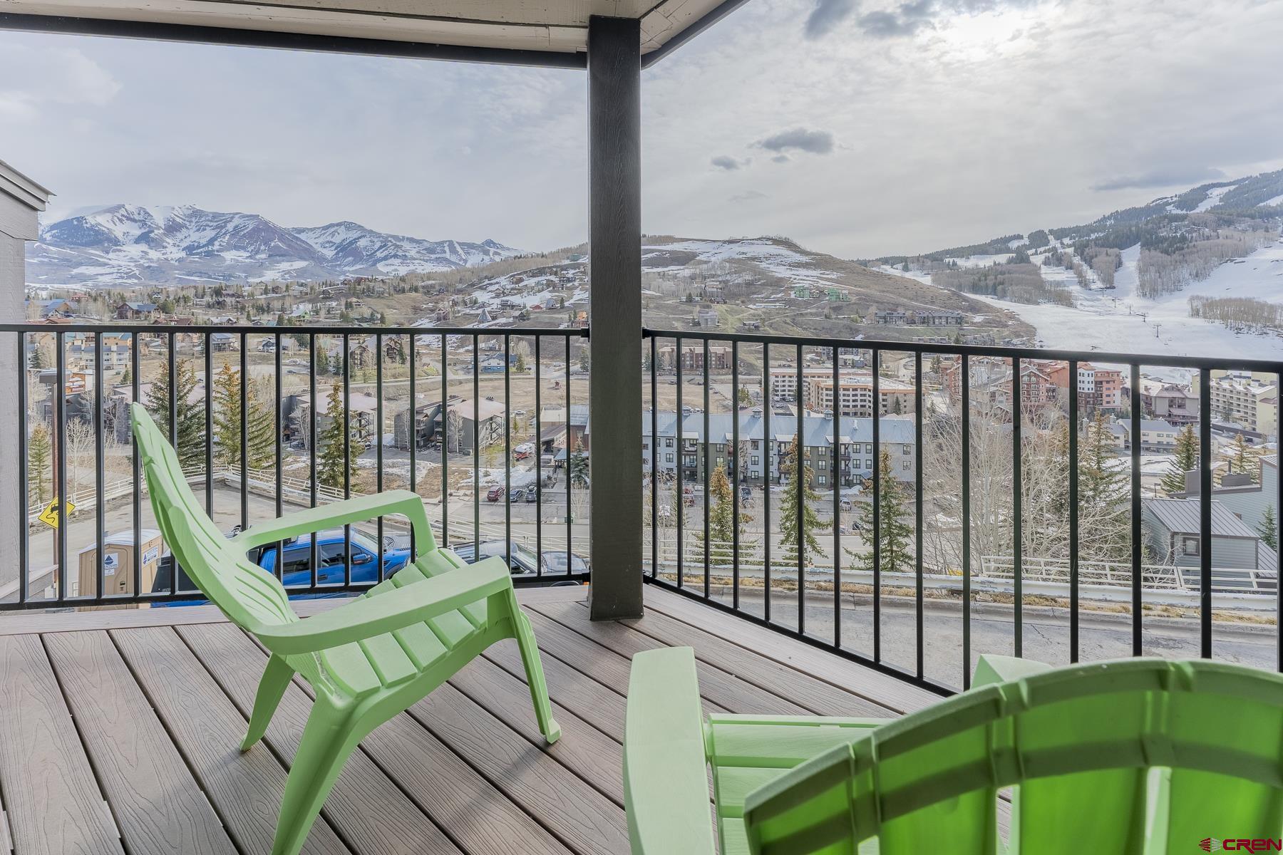 11 Morning Glory Way, Unit 14 Crested Butte, CO 81225 - Photo 6 of 44 a view of a balcony with wooden floor and a potted plant