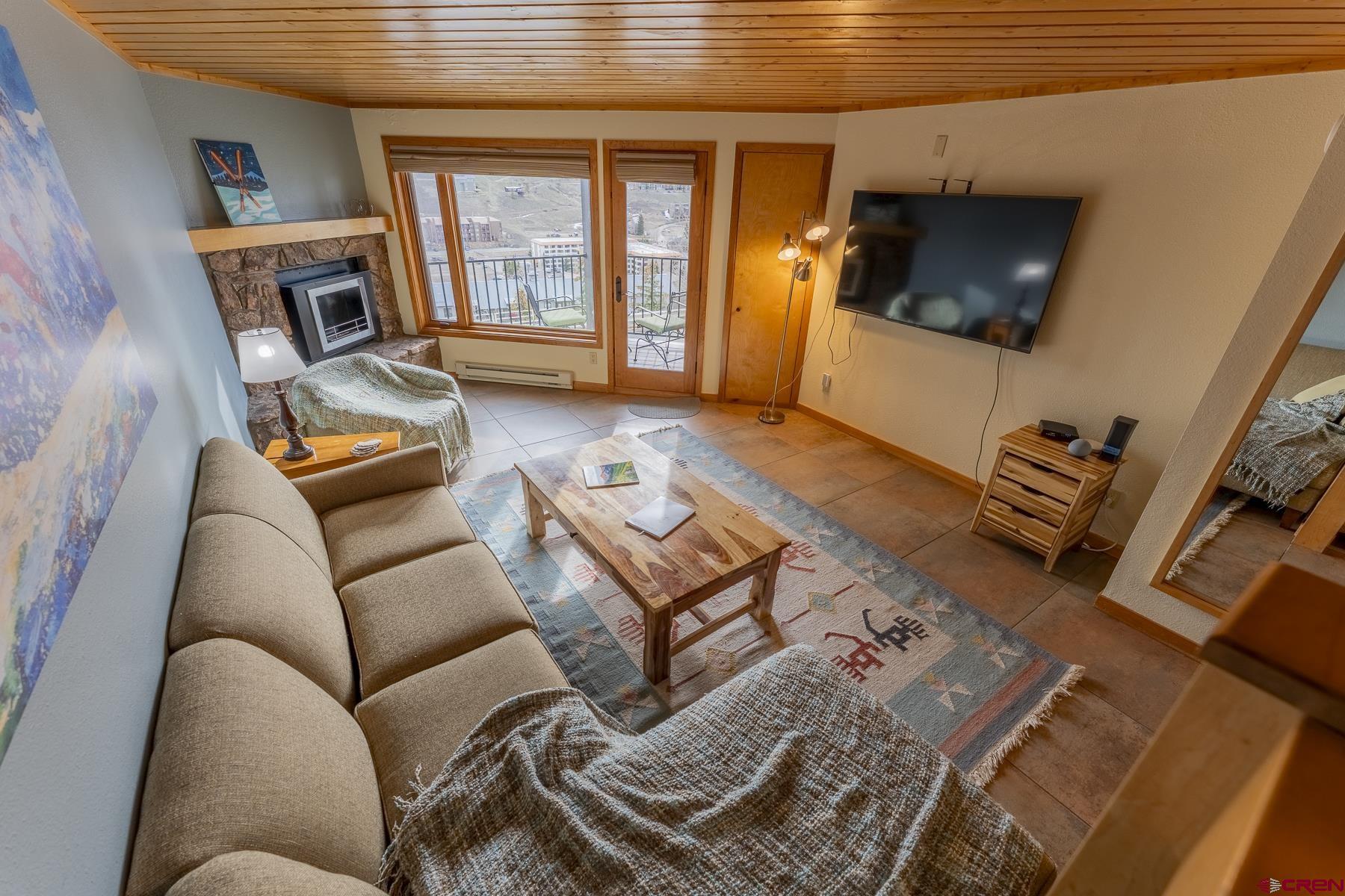 11 Morning Glory Way, Unit 14 Crested Butte, CO 81225 - Photo 9 of 44 a living room with furniture and a flat screen tv
