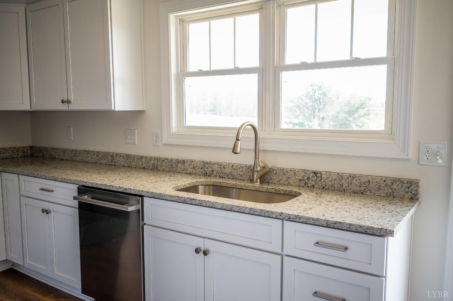 10578 Leesville Road Lynch Station, VA 24571 - Photo 11 of 54 a kitchen with granite countertop a sink window and cabinets