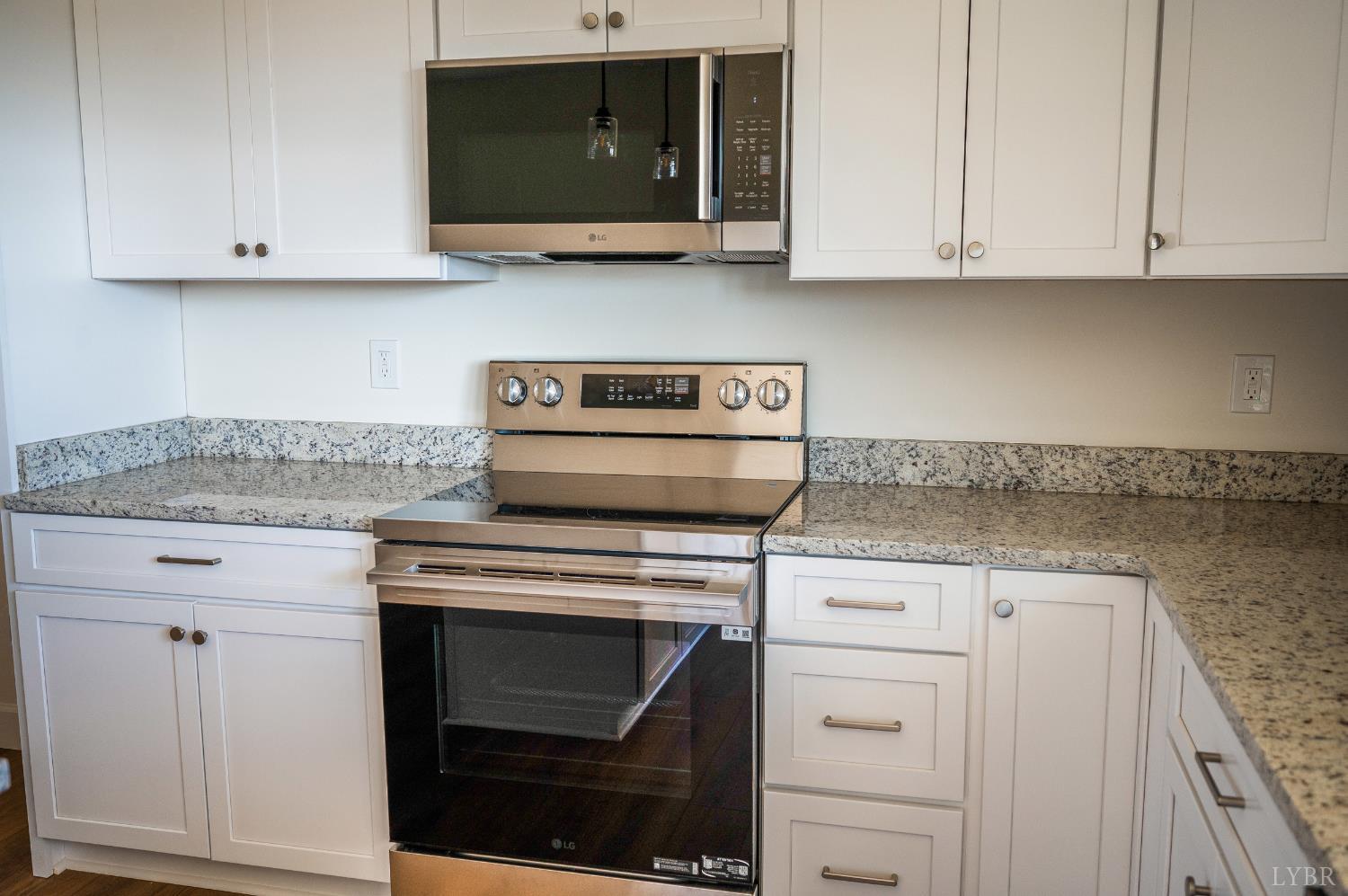 10578 Leesville Road Lynch Station, VA 24571 - Photo 12 of 54 a kitchen with granite countertop white cabinets and stainless steel appliances