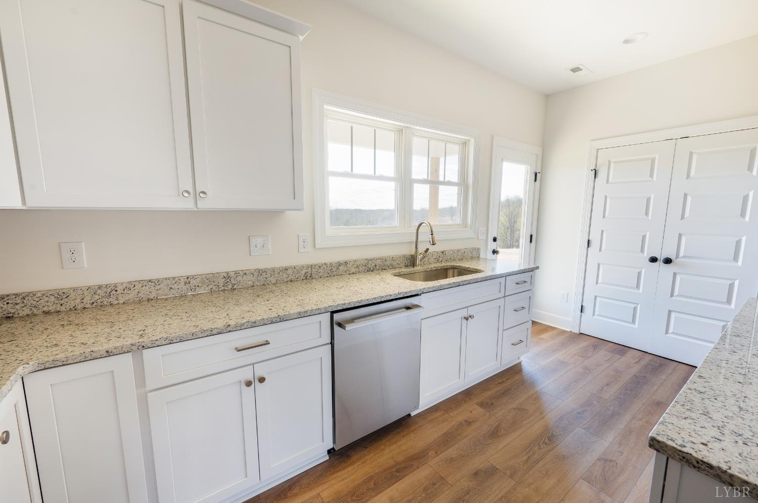 10578 Leesville Road Lynch Station, VA 24571 - Photo 14 of 54 a kitchen with granite countertop white cabinets and sink