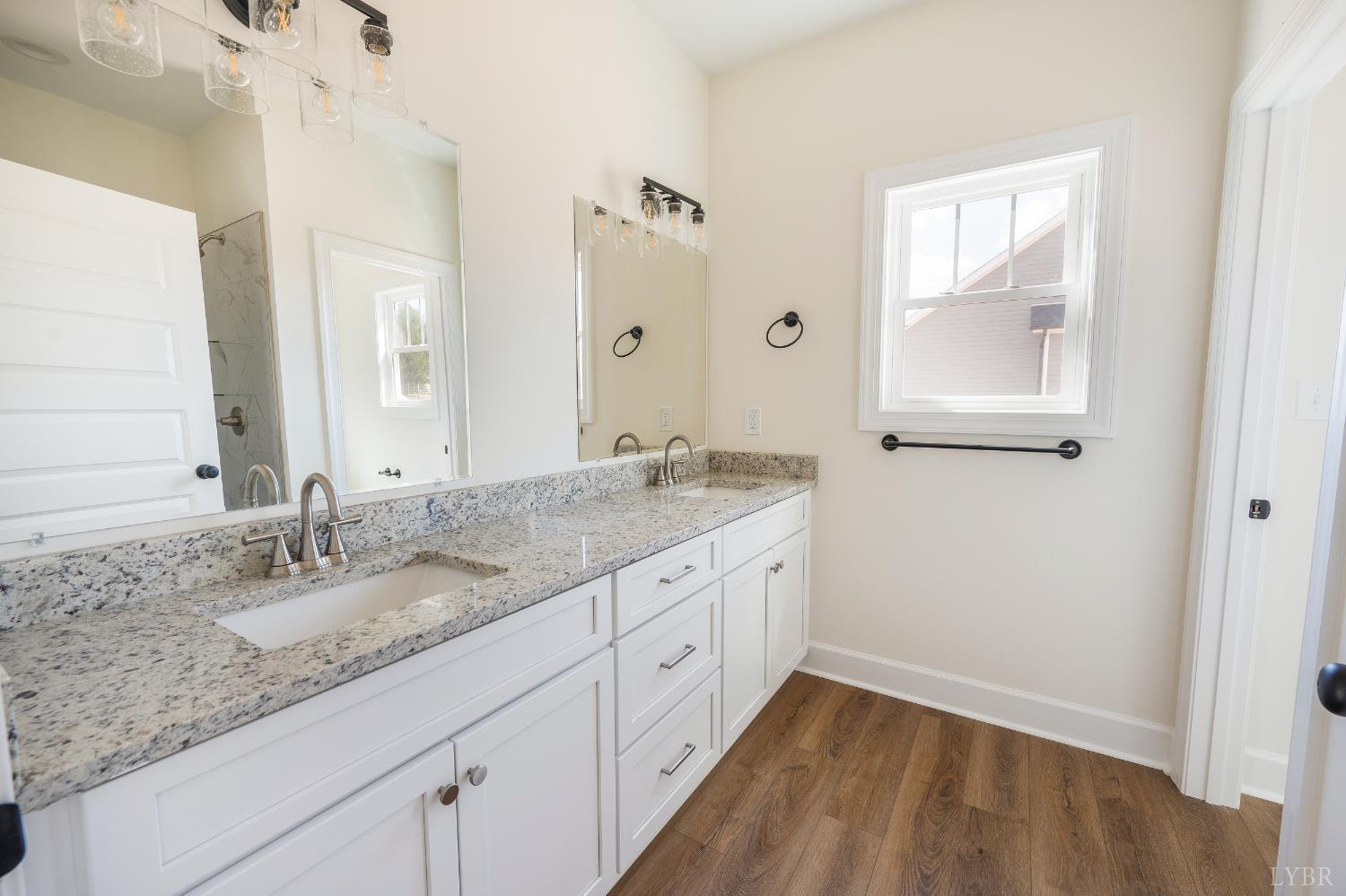10578 Leesville Road Lynch Station, VA 24571 - Photo 22 of 54 a bathroom with a granite countertop sink a large mirror a and a