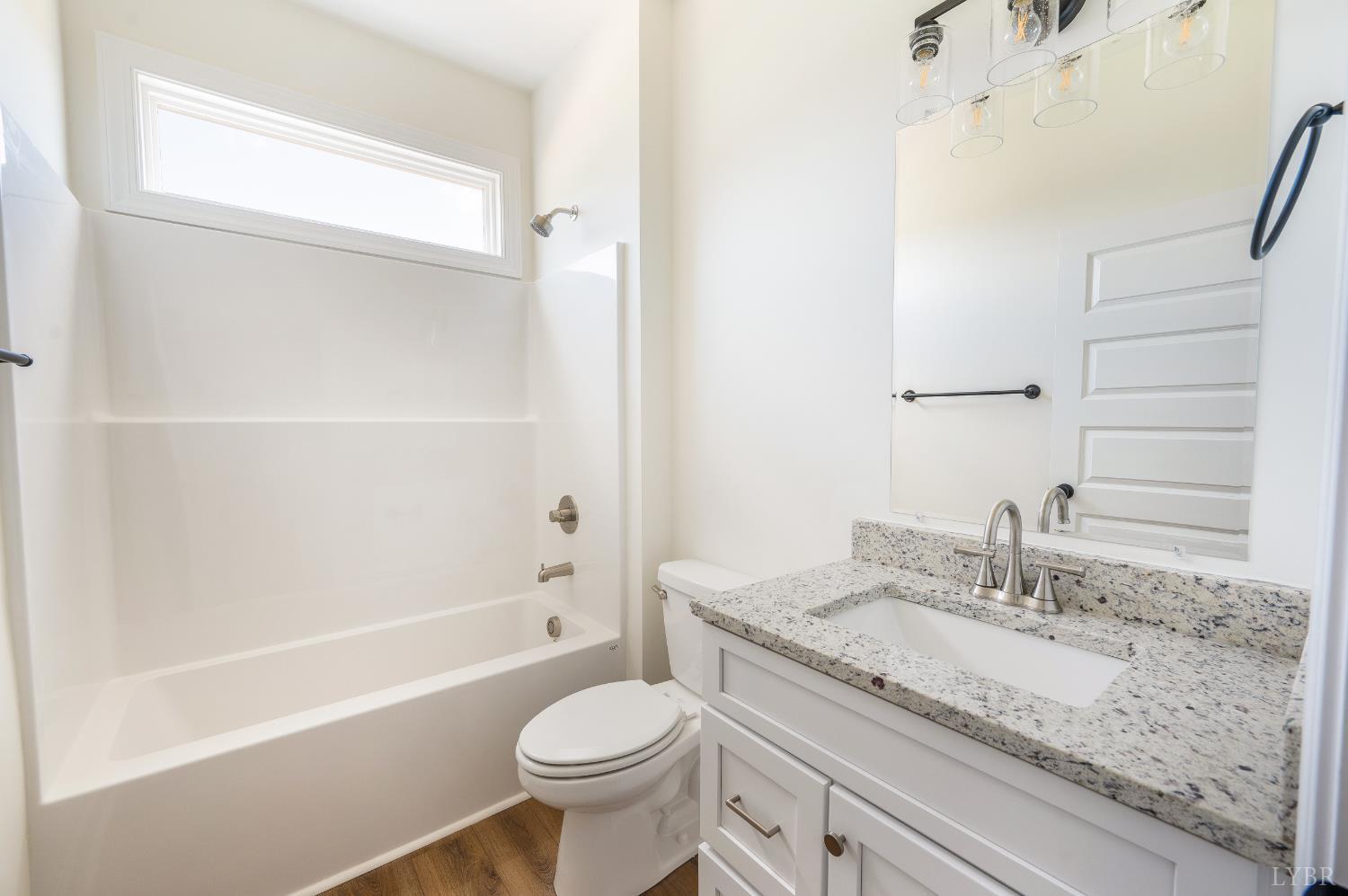 10578 Leesville Road Lynch Station, VA 24571 - Photo 29 of 54 a bathroom with a granite countertop sink a toilet and bathtub
