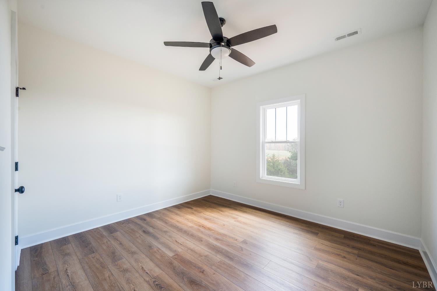 10578 Leesville Road Lynch Station, VA 24571 - Photo 30 of 54 wooden floor in an empty room with a window