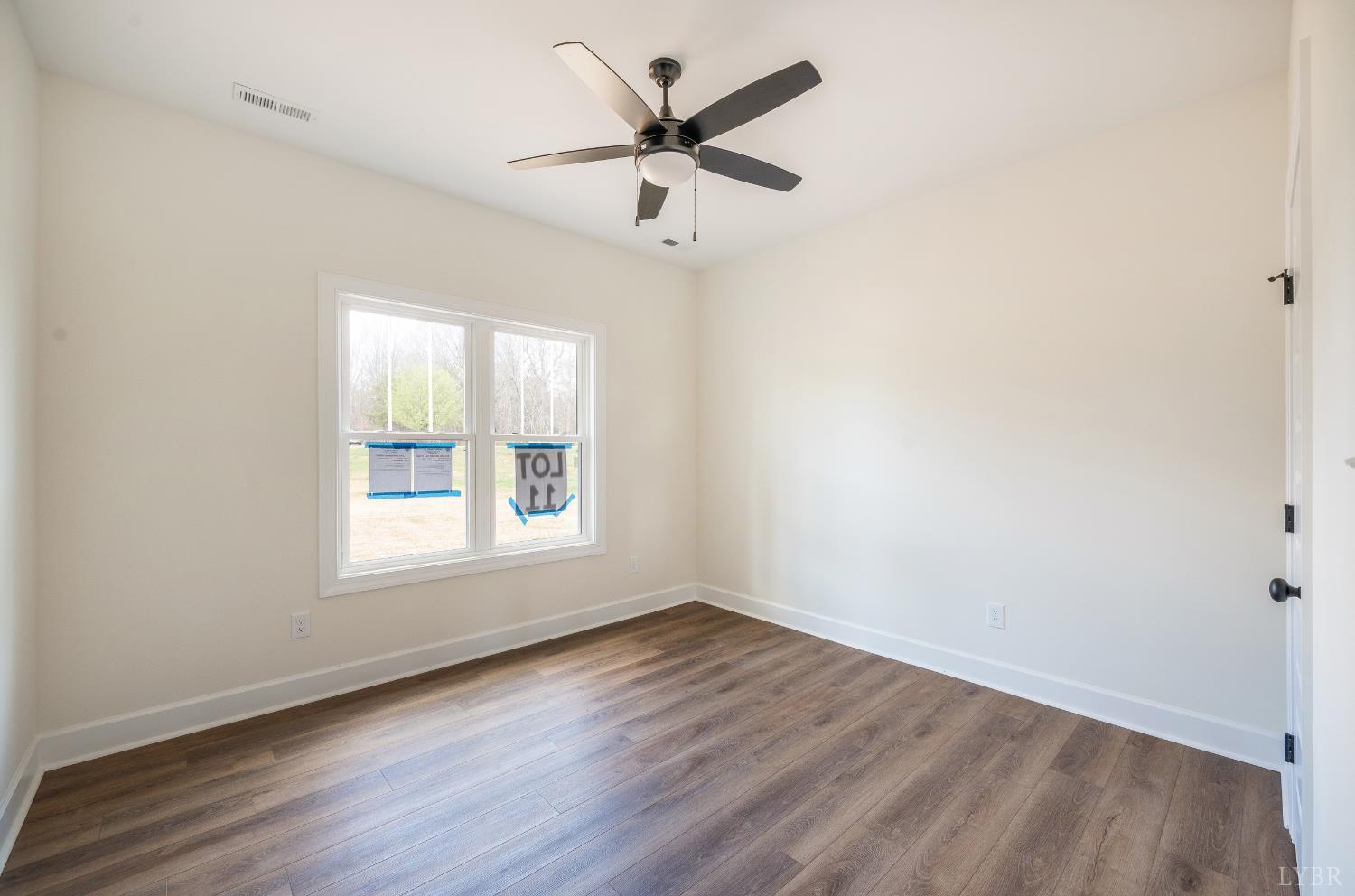 10578 Leesville Road Lynch Station, VA 24571 - Photo 32 of 54 an empty room with wooden floor and windows