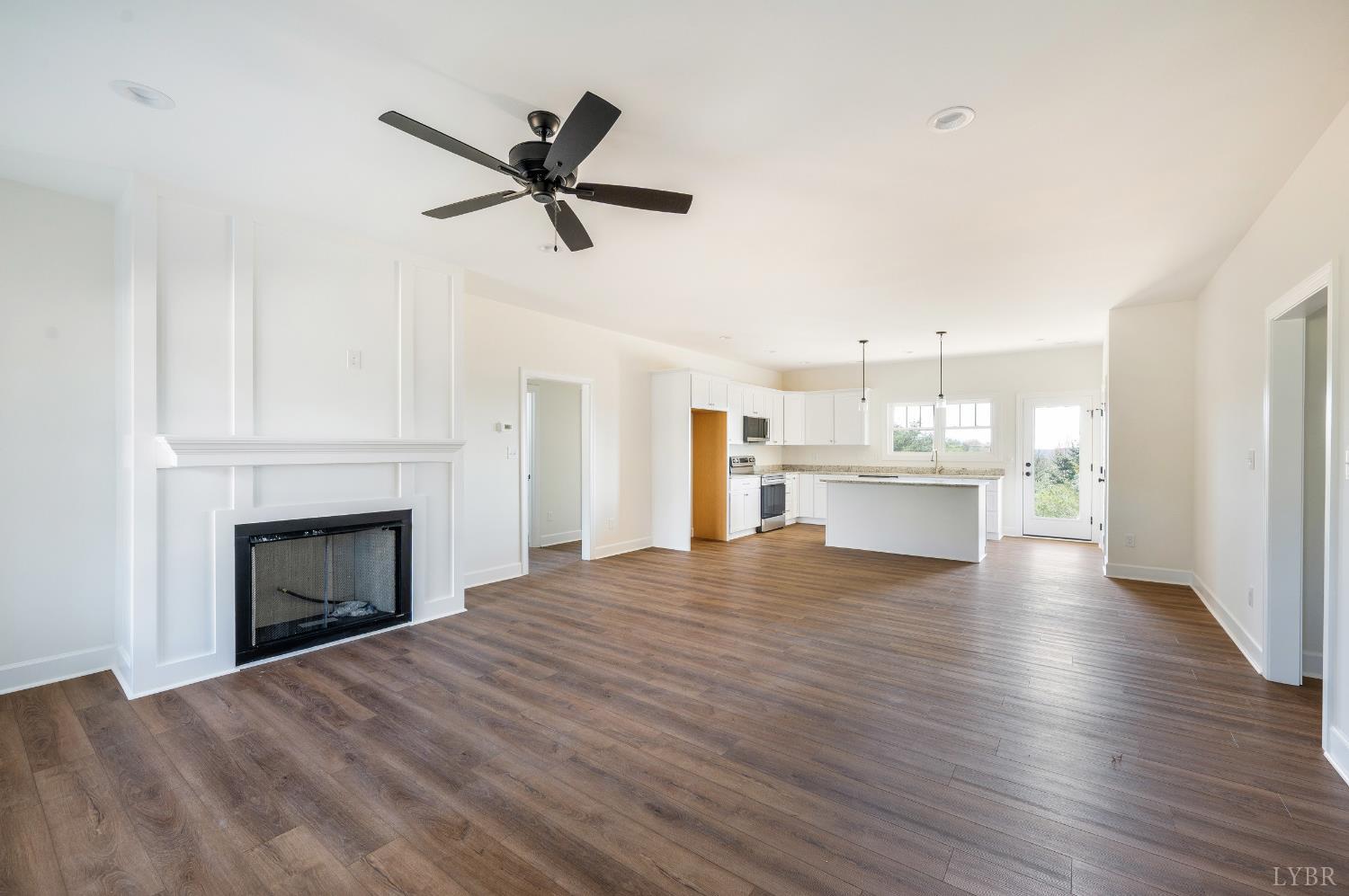 10578 Leesville Road Lynch Station, VA 24571 - Photo 4 of 54 a view of a livingroom with a fireplace a ceiling fan and wooden floor