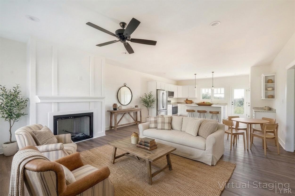 10578 Leesville Road Lynch Station, VA 24571 - Photo 5 of 54 a living room with furniture a fireplace and a chandelier