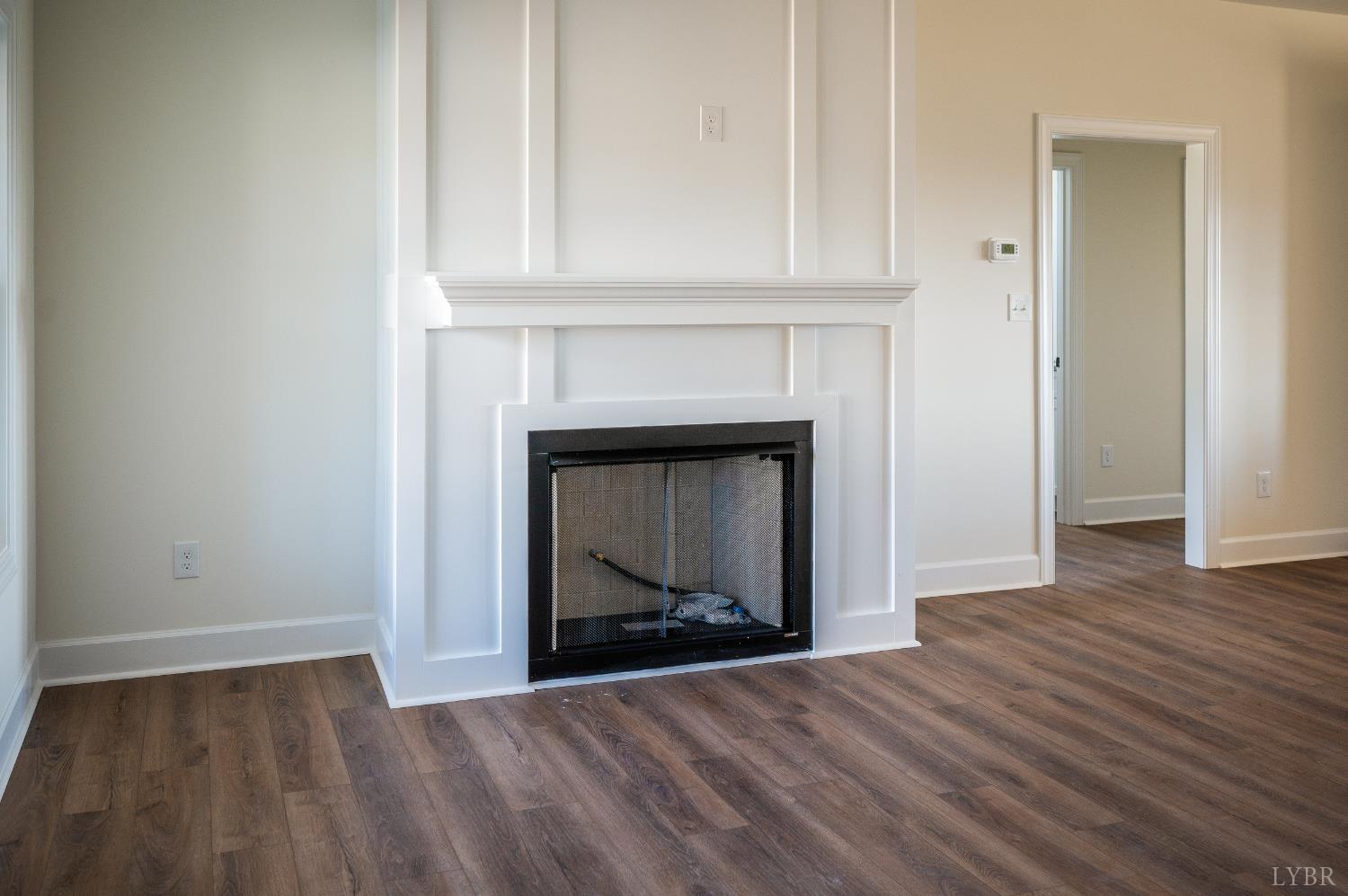 10578 Leesville Road Lynch Station, VA 24571 - Photo 7 of 54 a view of an empty room with wooden floor and fireplace