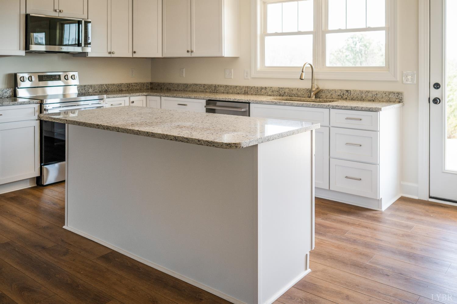 10578 Leesville Road Lynch Station, VA 24571 - Photo 10 of 54 a kitchen with granite countertop white cabinets and white appliances