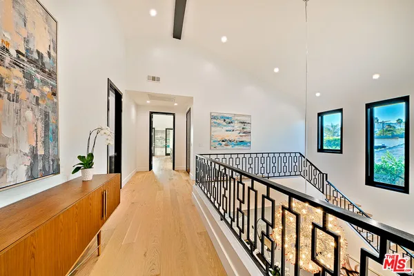 a bedroom with furniture and flat screen tv