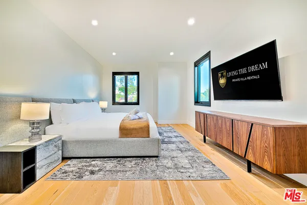 a bathroom with a bathtub a sink a mirror and a shower