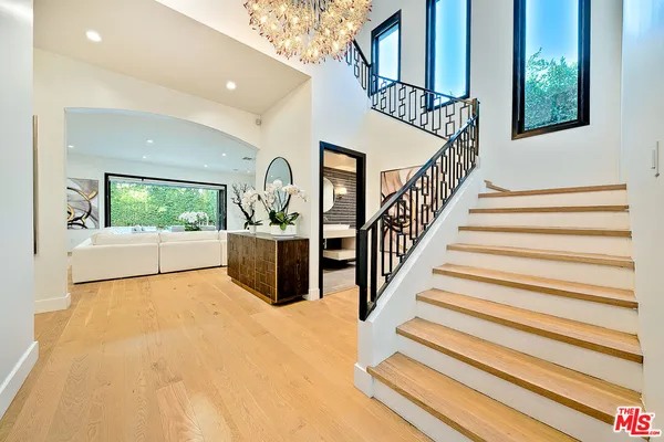 a view of entryway and hall with wooden floor