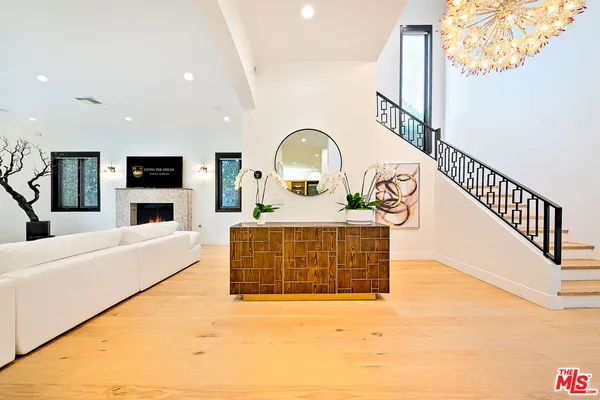 a view of a living room with a fireplace and a flat screen tv