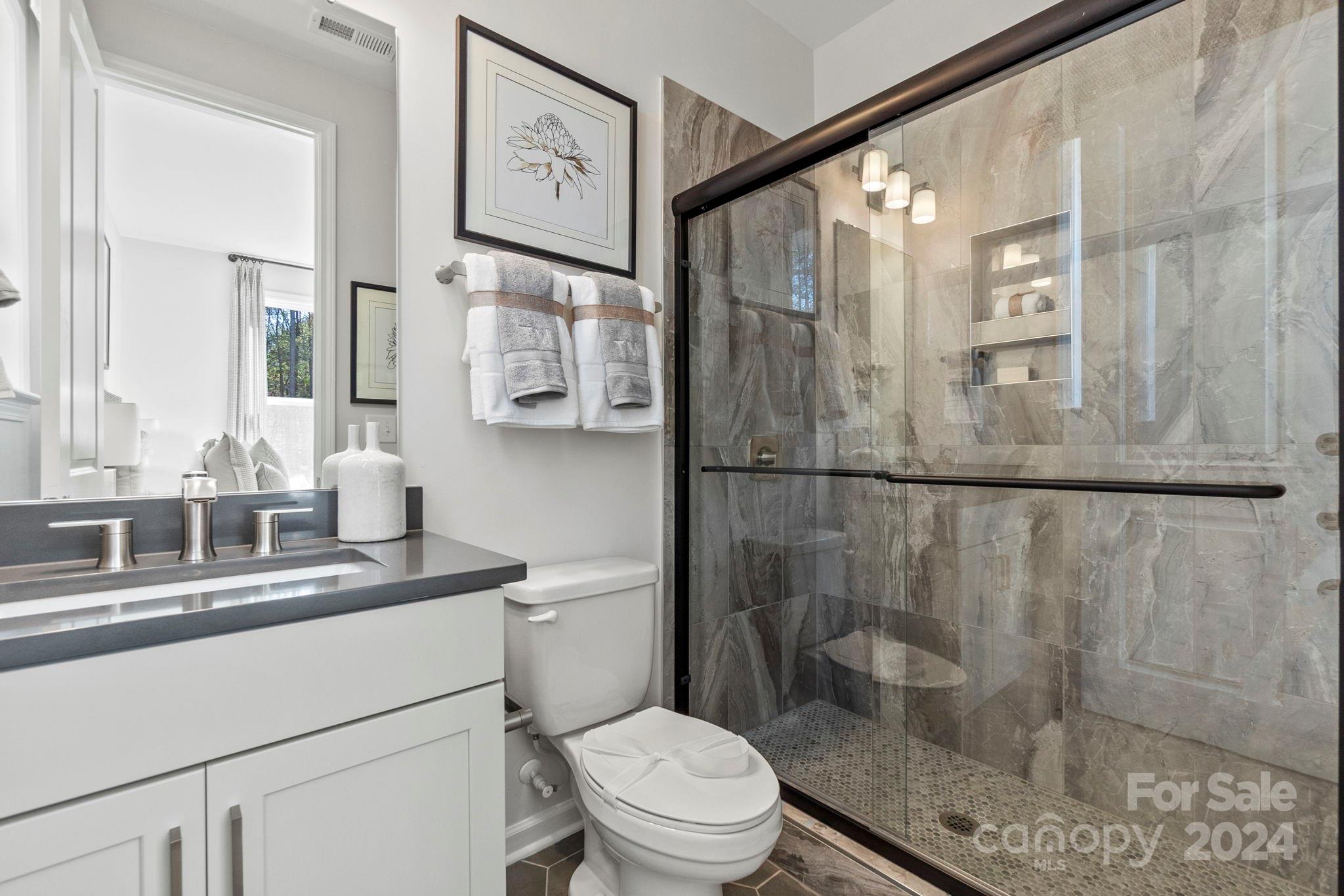 13229 Chopin Ridge Road Huntersville, NC 28078 - Photo 19 of 34 a bathroom with a sink a toilet and shower