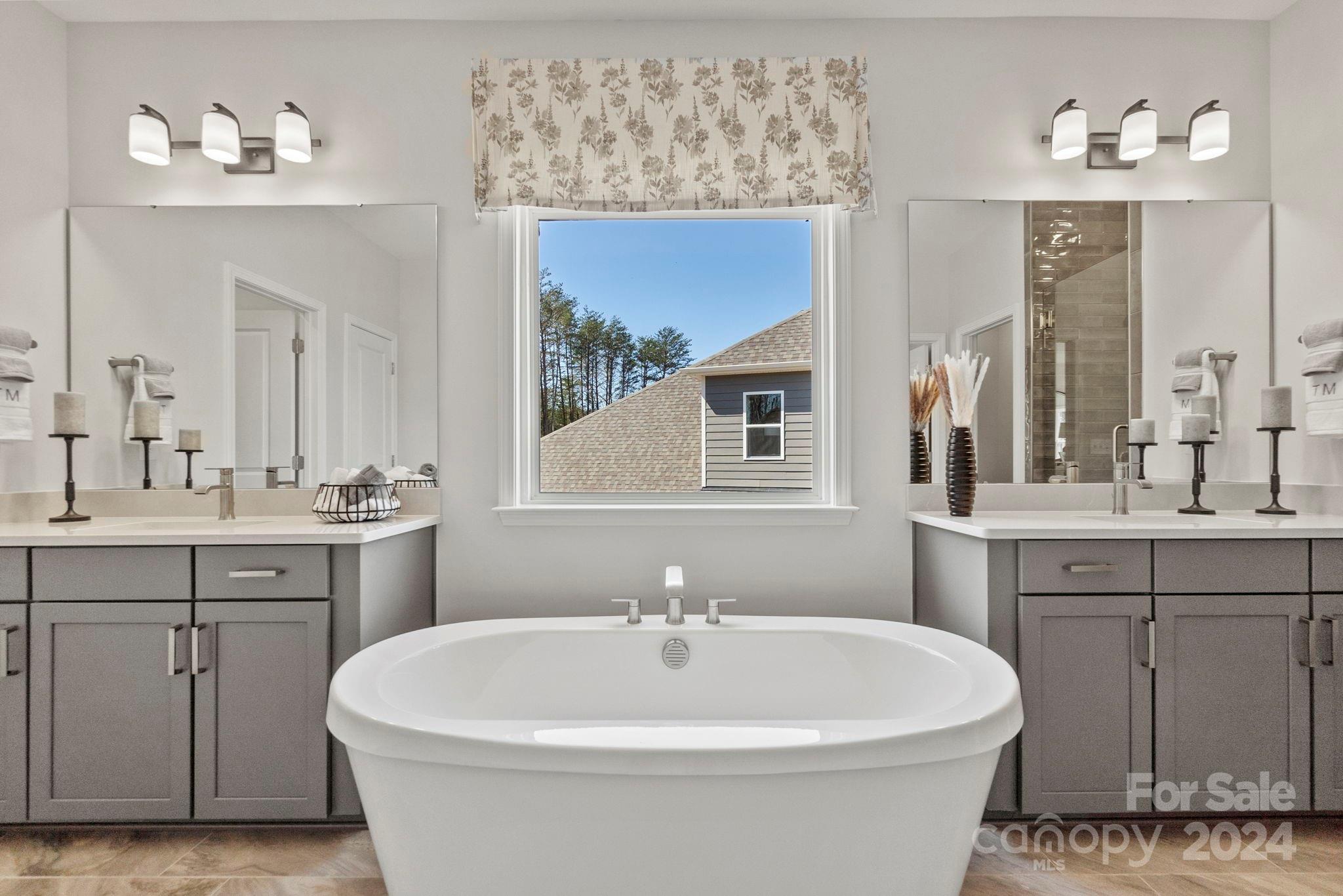 13229 Chopin Ridge Road Huntersville, NC 28078 - Photo 22 of 34 a white bath tub sitting next to a bathroom sink