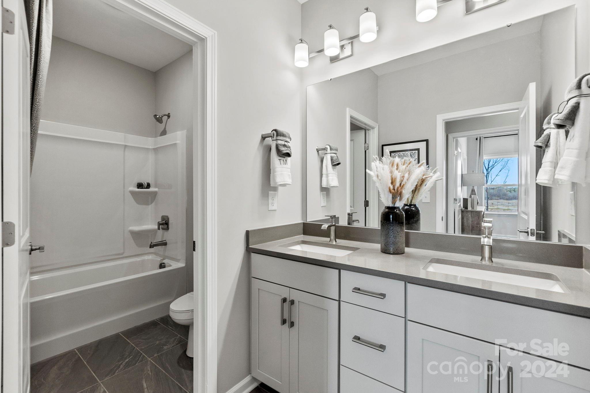 13229 Chopin Ridge Road Huntersville, NC 28078 - Photo 27 of 34 a bathroom with a tub a sink double vanity and a mirror