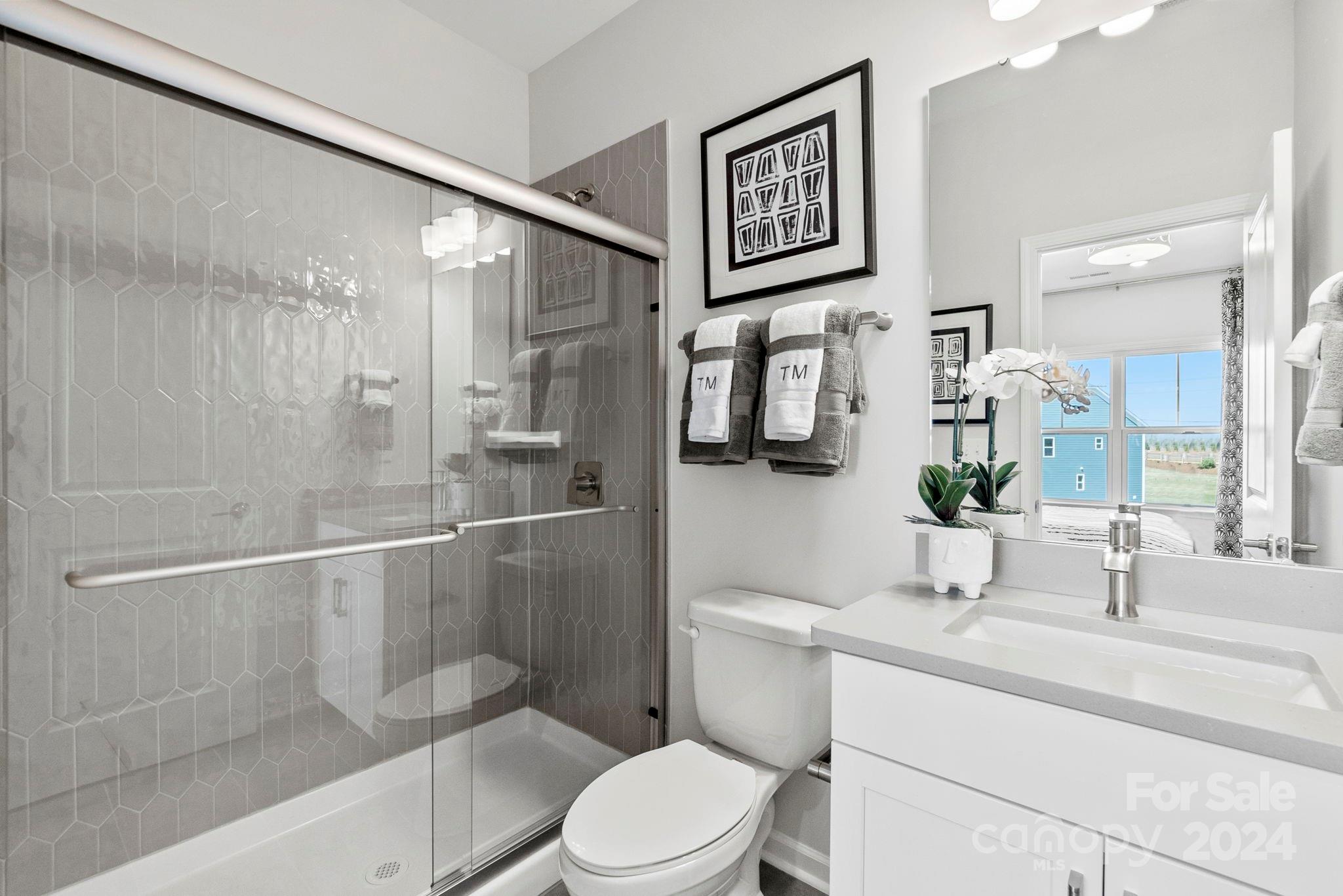13229 Chopin Ridge Road Huntersville, NC 28078 - Photo 29 of 34 a bathroom with a toilet sink and shower