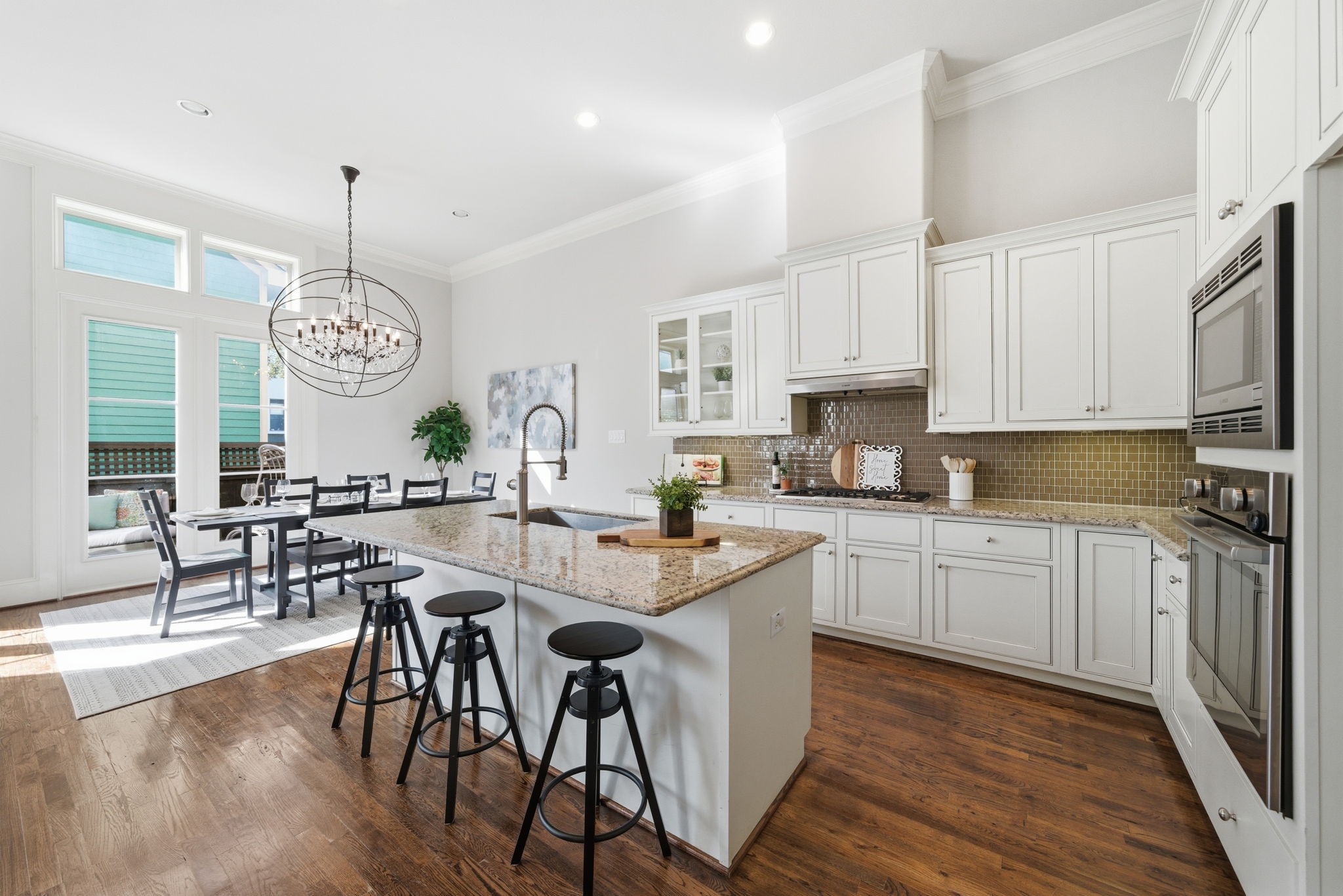 1360 West 25th Street Houston, TX 77008 - Photo 11 of 37 a open kitchen with stainless steel appliances granite countertop a stove top oven a sink dishwasher a dining table and chairs with wooden floor