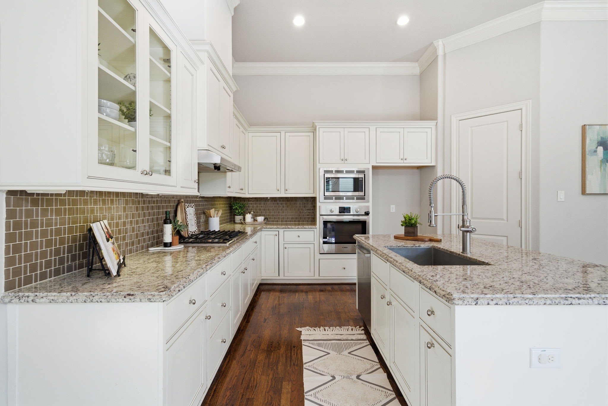 1360 West 25th Street Houston, TX 77008 - Photo 13 of 37 a kitchen with granite countertop a sink stove and cabinets
