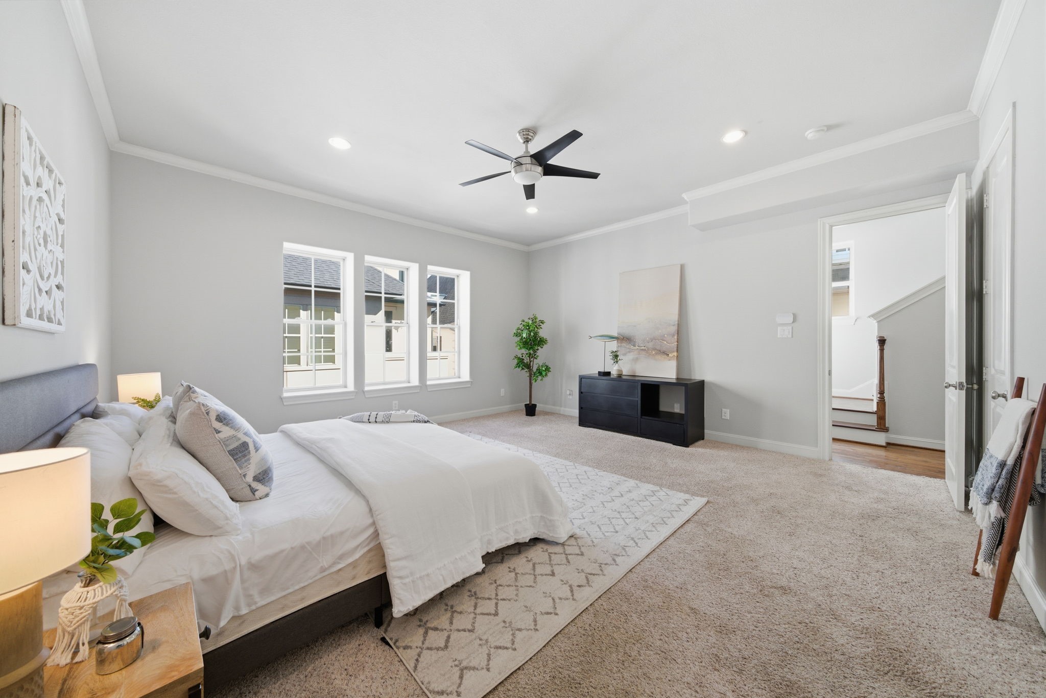 1360 West 25th Street Houston, TX 77008 - Photo 19 of 37 a spacious bedroom with a large bed and a chandelier