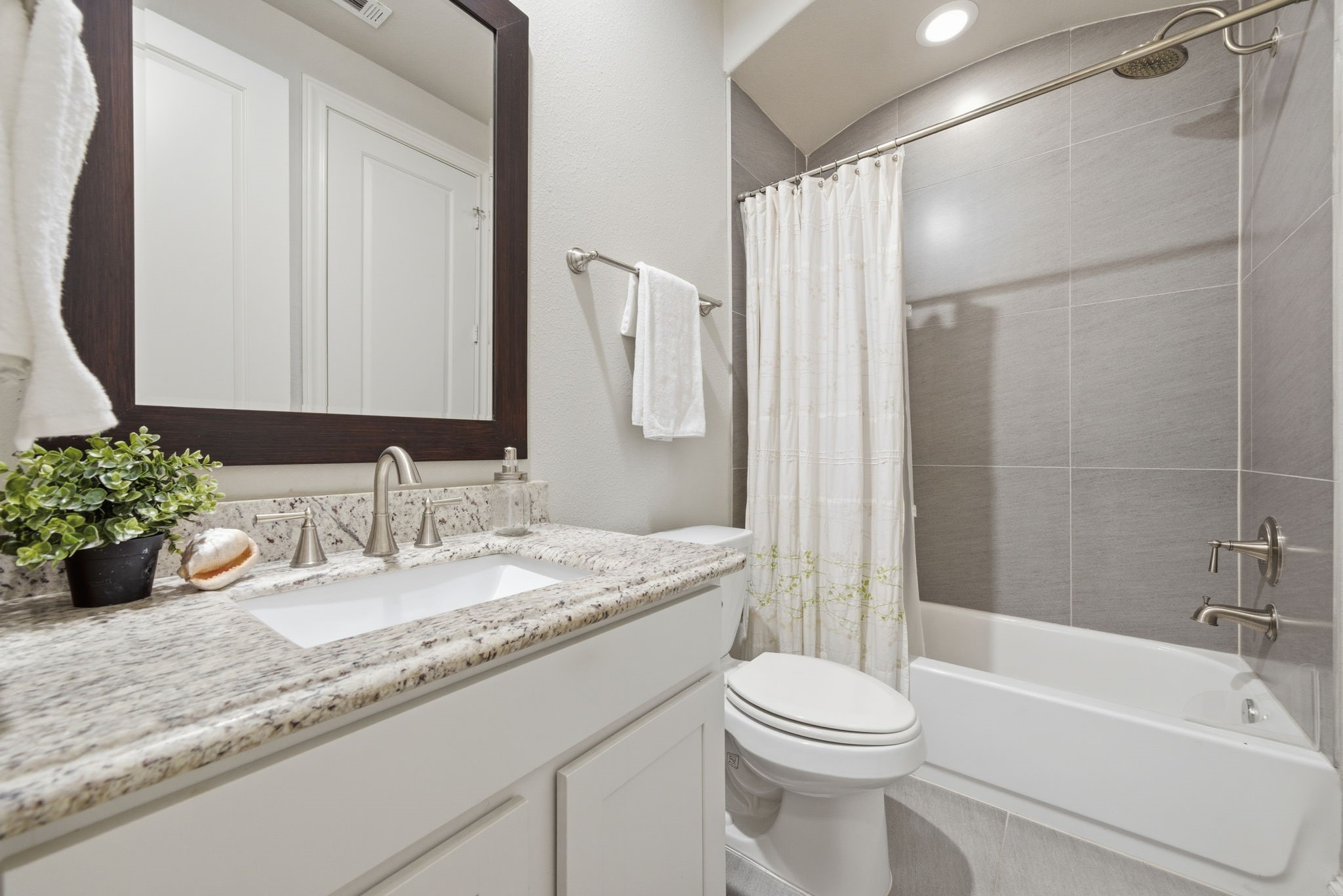 1360 West 25th Street Houston, TX 77008 - Photo 31 of 37 a bathroom with a granite countertop sink toilet and shower