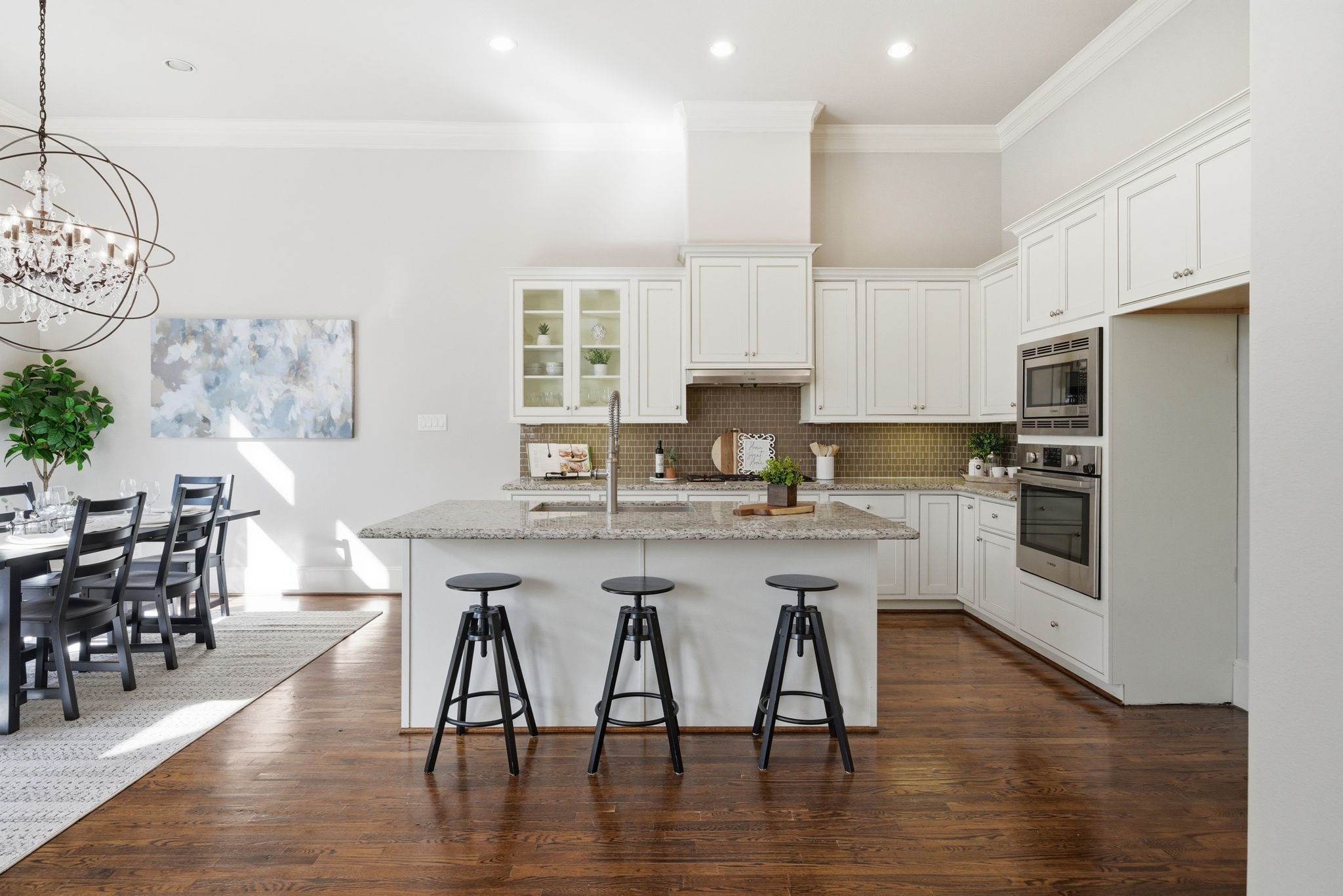 1360 West 25th Street Houston, TX 77008 - Photo 10 of 37 a kitchen with stainless steel appliances granite countertop a stove top oven a sink a dining table and chairs with wooden floor