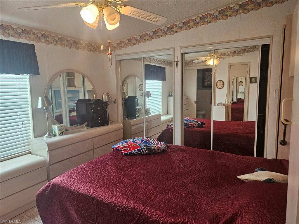 27 Amethyst Avenue, Unit 27A Naples, FL 34114 - Photo 14 of 27 a bedroom with a bed and a mirror on dresser
