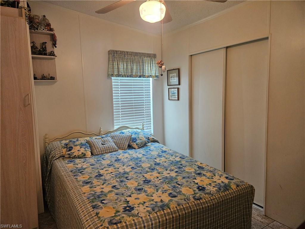 27 Amethyst Avenue, Unit 27A Naples, FL 34114 - Photo 15 of 27 a bedroom with a bed and a window