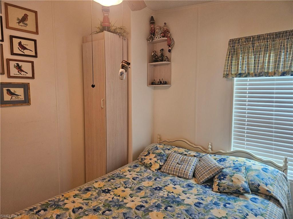 27 Amethyst Avenue, Unit 27A Naples, FL 34114 - Photo 16 of 27 a bedroom with a bed and a window