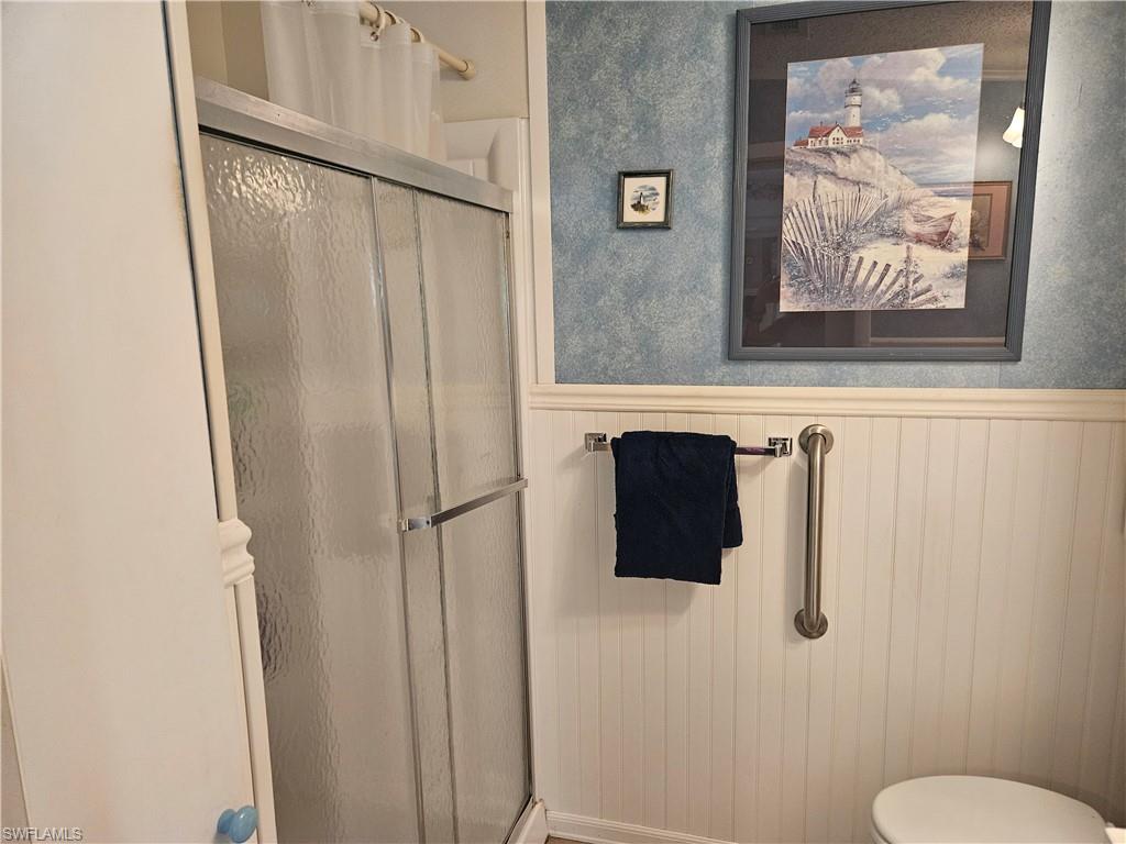 27 Amethyst Avenue, Unit 27A Naples, FL 34114 - Photo 20 of 27 a bathroom with a sink and mirror