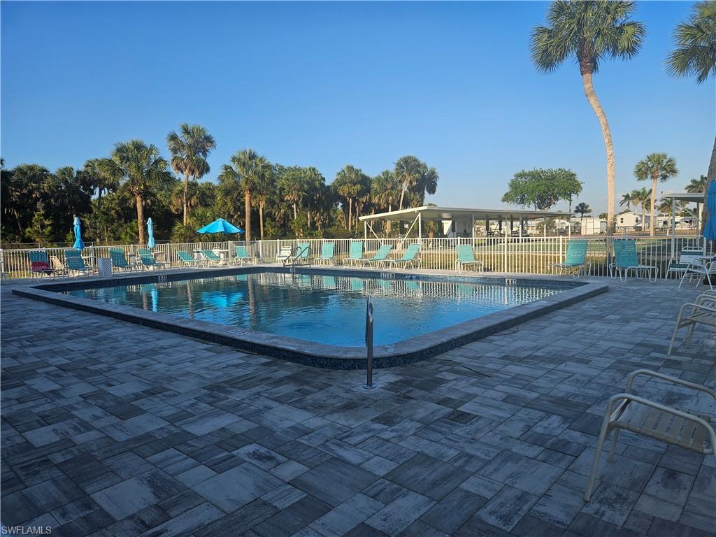 27 Amethyst Avenue, Unit 27A Naples, FL 34114 - Photo 26 of 27 a view of a swimming pool with a yard