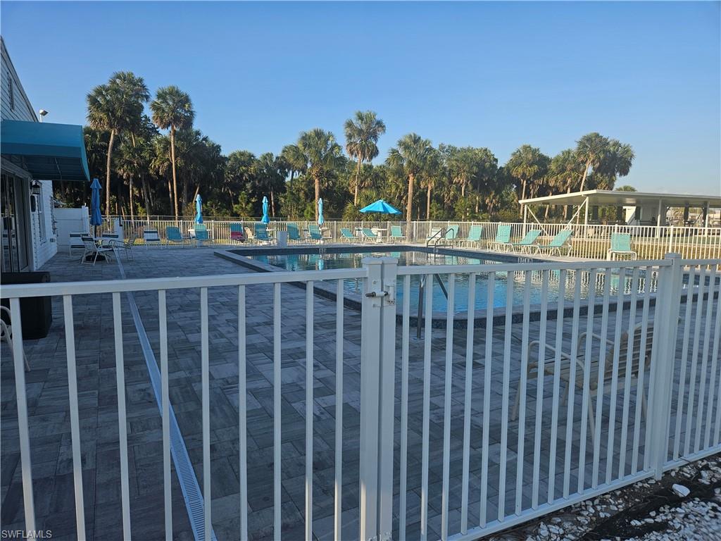 27 Amethyst Avenue, Unit 27A Naples, FL 34114 - Photo 27 of 27 a view of a balcony with a garden