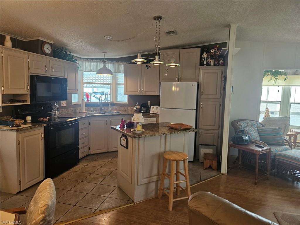 27 Amethyst Avenue, Unit 27A Naples, FL 34114 - Photo 7 of 27 a kitchen with a sink cabinets and appliances