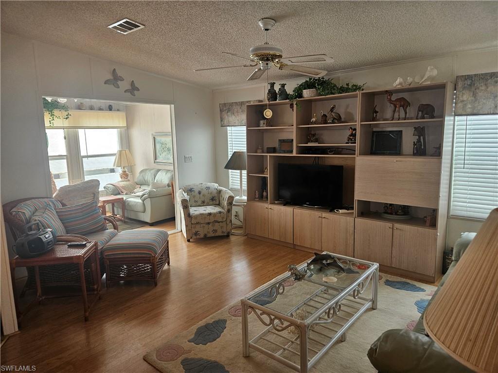 27 Amethyst Avenue, Unit 27A Naples, FL 34114 - Photo 9 of 27 a living room with furniture and a flat screen tv