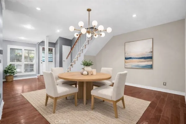 a view of a dining room with furniture wooden floor and chandelier