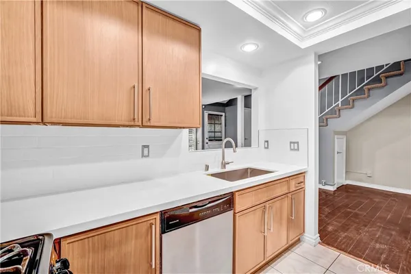 a kitchen with stainless steel appliances granite countertop a sink and a white cabinets